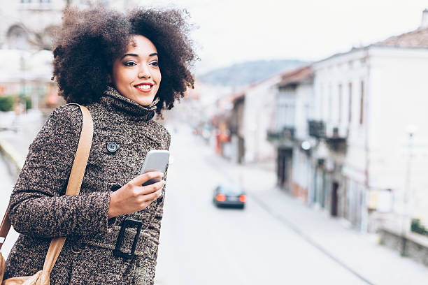 istock Smiling young woman standing on street 637621444