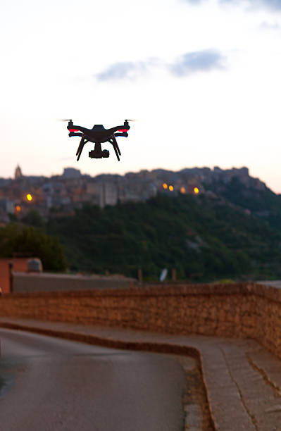istock Small Drone with Camera Flies Down Village Street, Italy 637622686