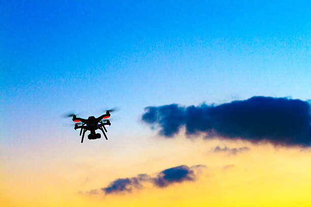 istock Small Drone with Camera Flies in Colorful Sunset 637622716