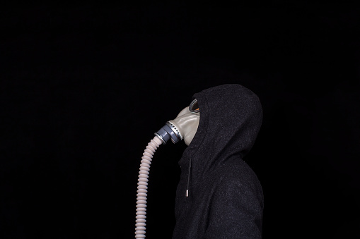 office man wearing gas mask, in tweed coat