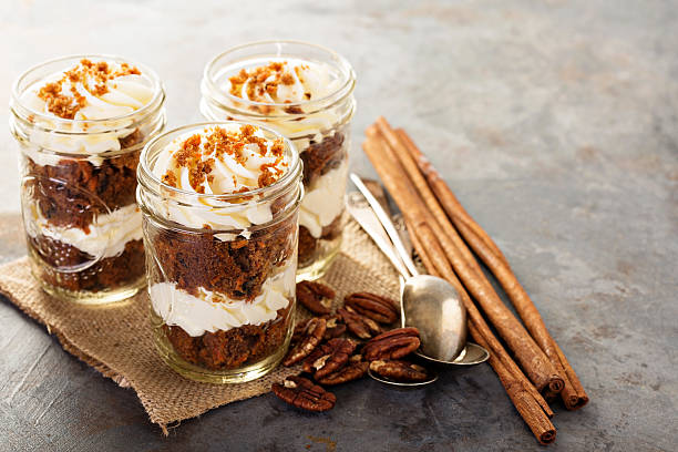 Carrot cake in a jar Carrot cake in a jar with pecan nuts and cinnamon cake jar stock pictures, royalty-free photos & images