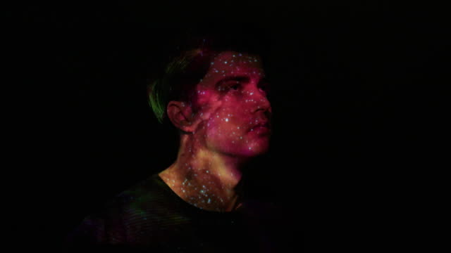 Projection of nebula and stars on a man's face
