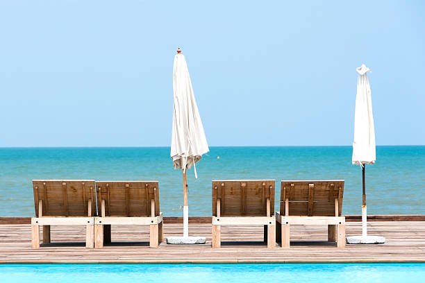 istock Chairs with White Umbrella near the Beach 637629864
