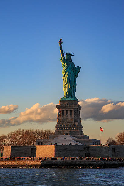 istock Statue of liberty with clouds. 637630310
