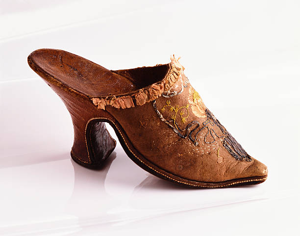 istock Old brown leather sandal with embroidery on reflection background 637631096