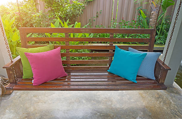 istock Four pillow  Placed on a wooden swing in the 637632554