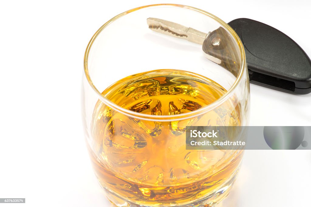 A glass of whiskey and a car key Alcohol and a key to a car Addiction Stock Photo