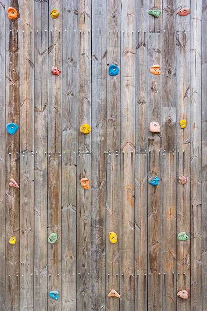 istock Old wood climbing wall with toe and hand hold studs. 637633692