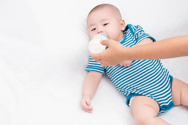 istock Adorable baby drinking milk 637635112