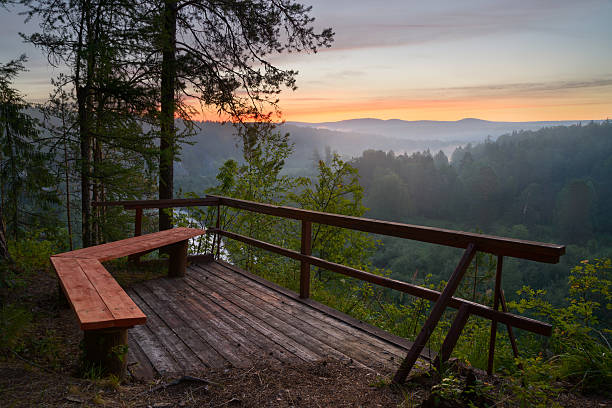 istock bench with view of sunrise 637636138