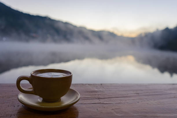 istock Cup of hot coffee put on old wooden table background 637637146