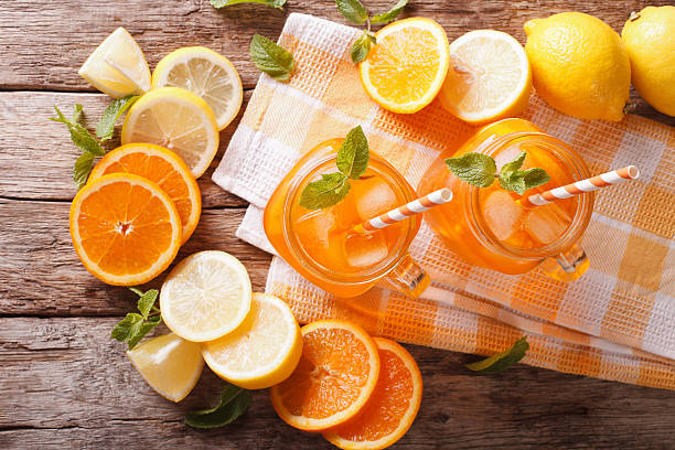 istock Orange cocktail with ice and mint in a glass jar 637637858
