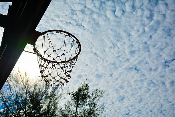 istock The basketball hoop under the cloudy sky and sun light 637639886