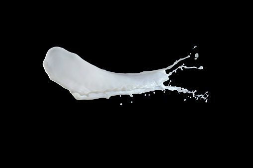 Splashing Milk, Paint Drop Liquid photographed on a black background. Vivid natural soft Beige-blue milk color tones.