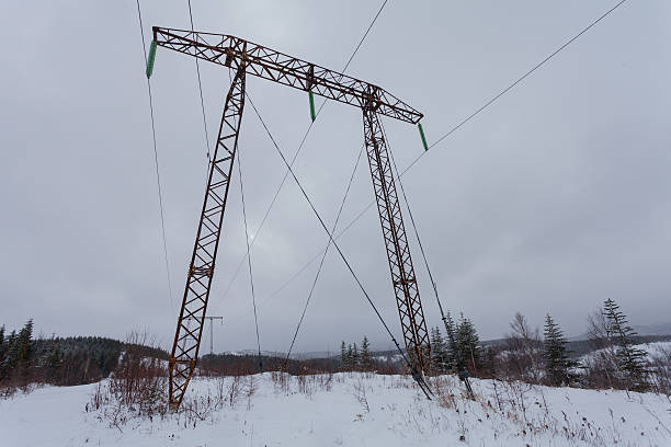istock Electricity transmission power lines on  winter background 637640836