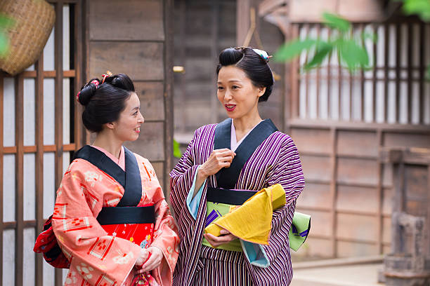 istock Two young Kimono women chatting in old Edo village 637641582