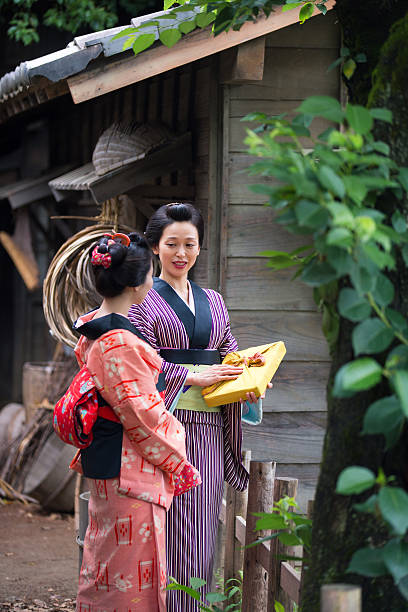 istock Two young Kimono women chatting in old Edo village 637641772
