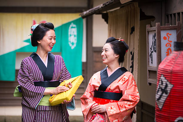 istock Two Kimono women talking in old Edo village with smile 637642072