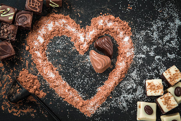istock Delicious chocolate candies, truffles in a cocoa heart shape. 637643210