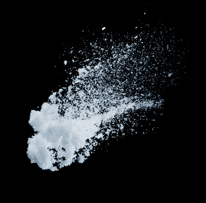 Isolated thrown snow against a black background