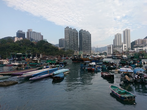 Hong kong port city traveling with boat in the sea