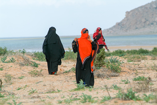 Socotra Island, Yemen - January 16, 2008: women dressed in the burqa walking on the countryside of Socotra island, Yemen