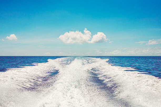 Background water surface behind fast moving motor boat vintage retro Background water surface behind of fast moving motor boat in vintage retro style sea wake stock pictures, royalty-free photos & images