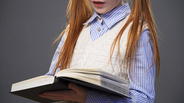 istock Close up girl holding a book 637663258