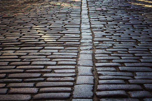istock Old cobbled stone pavement, paving close-up 637667782