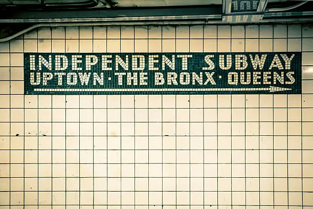 Retro tiled wall in New York City subway station with vintage filter effect