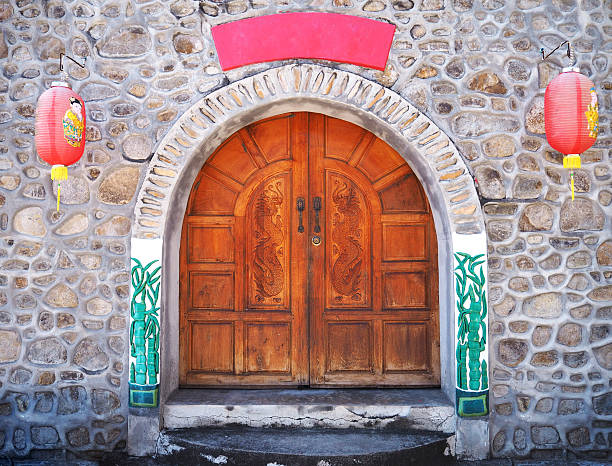 istock Chinese wooden door style with two red lanterns. 637670842