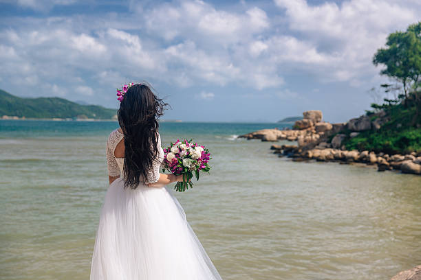 istock bride in an elegant white dress with a bouquet in 637673774