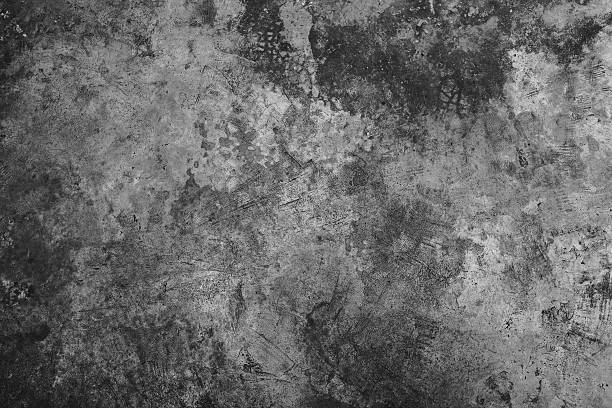 istock Dark grunge textured cement wall closeup 637673908