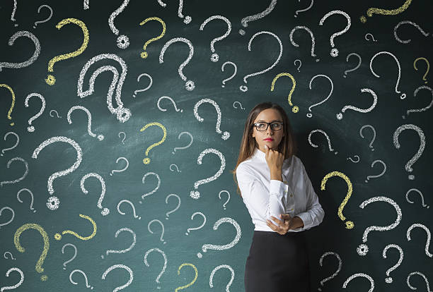 istock Businesswoman and question marks on blackboard 637675408