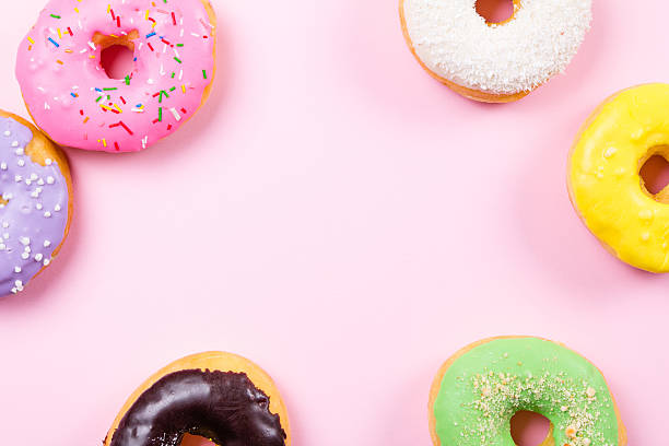 istock Colorful round donuts on pink background. Flat lay, top view. 637677996