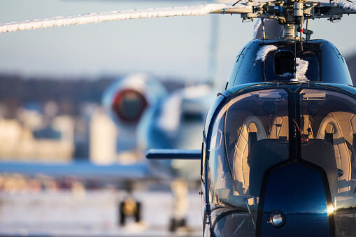 Pilot Helicopter Emergency Medical Service during flight above forest. Close-up of flight control inside cockpit.