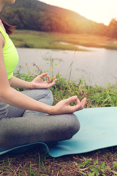 istock young woman meditates while practicing yoga outdoor 637683646