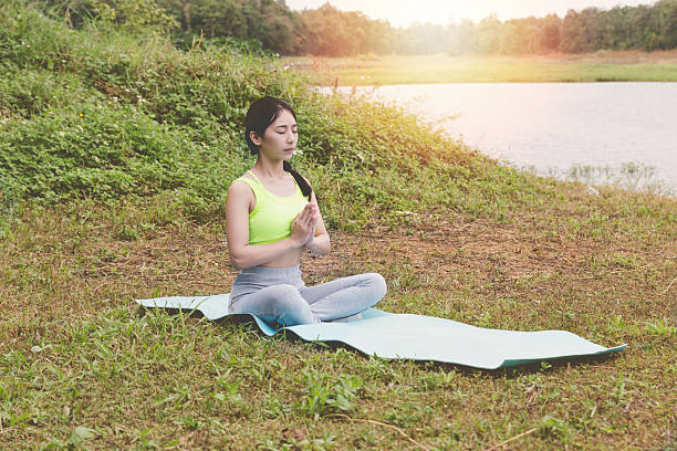 istock young woman meditates while practicing yoga outdoor 637685746
