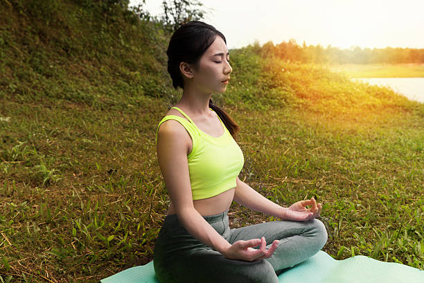 istock young woman meditates while practicing yoga outdoor 637685938