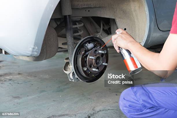Mechanic Spray Chemical To Clean Brake Stock Photo - Download Image Now - Brake, Cleaner, Car