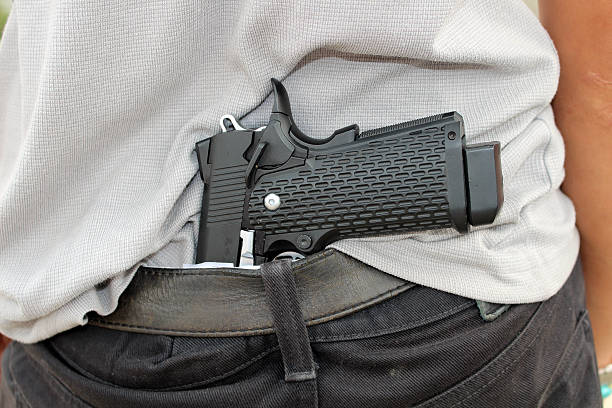 istock gangster concealing his gun behind his back 637690880