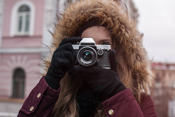 istock Hipster girl traveller with retro camera taking photo 637691168
