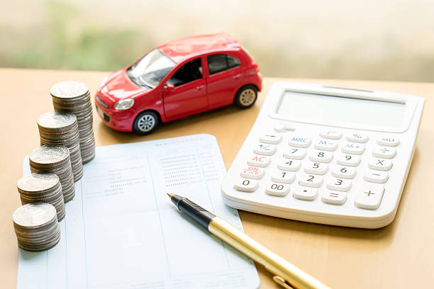 Coins stack in columns on saving book and car Coins stack in columns on saving book and car on finance concept land vehicle stock pictures, royalty-free photos & images