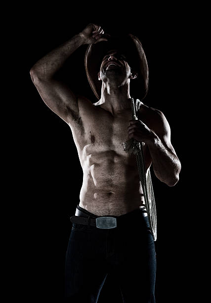 istock Shirtless cowboy looking up 637692146