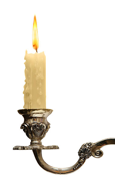 burning old candle vintage bronze Silver candlestick. Isolated On White stock photo