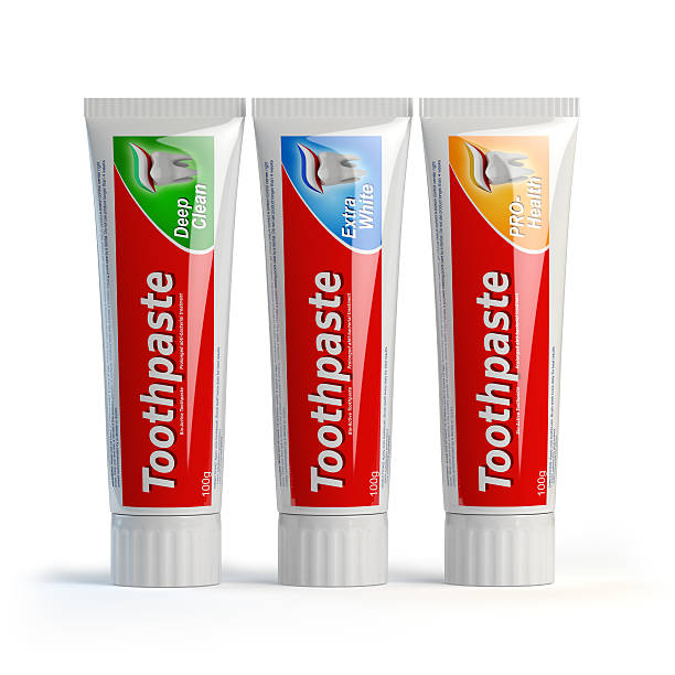 Three toothpaste containers on white isolated background. stock photo