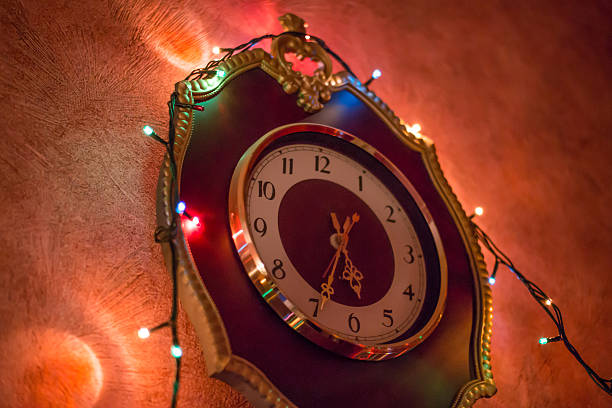istock Christmas lights on the old clock. Red wall. 637698932