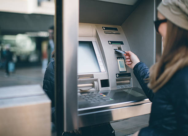 istock Young woman taking money from ATM 637704018