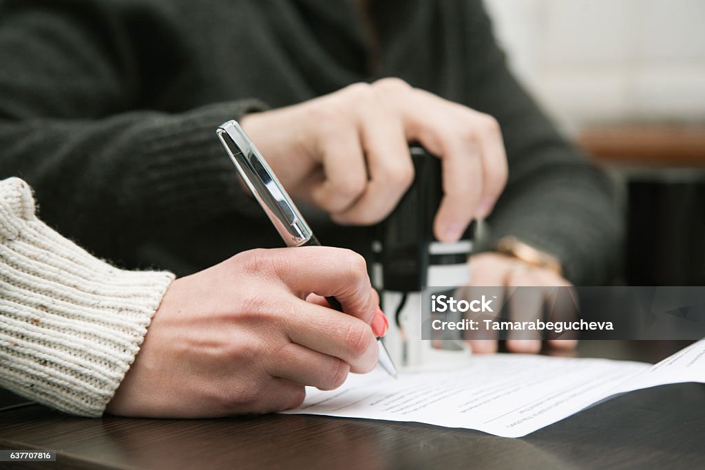Signing contract Notary public in office stamping document Intellectual Property Stock Photo