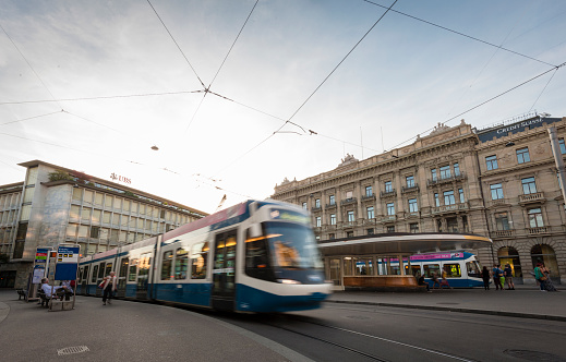 Zurich, Switzerland - September 7, 2014: A tramway train is leaving the tram station at Zurich's Paradeplatz in front of the headquarters of Switzerland's two largest banks UBS (left) and Credit Suisse (right) in the twilight of a quiet Sunday evening of September 7, 2014.